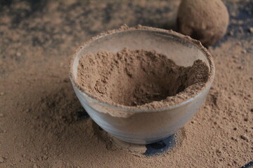 chocolate cake falls flying roll in cocoa powder. Preparation of dessert
