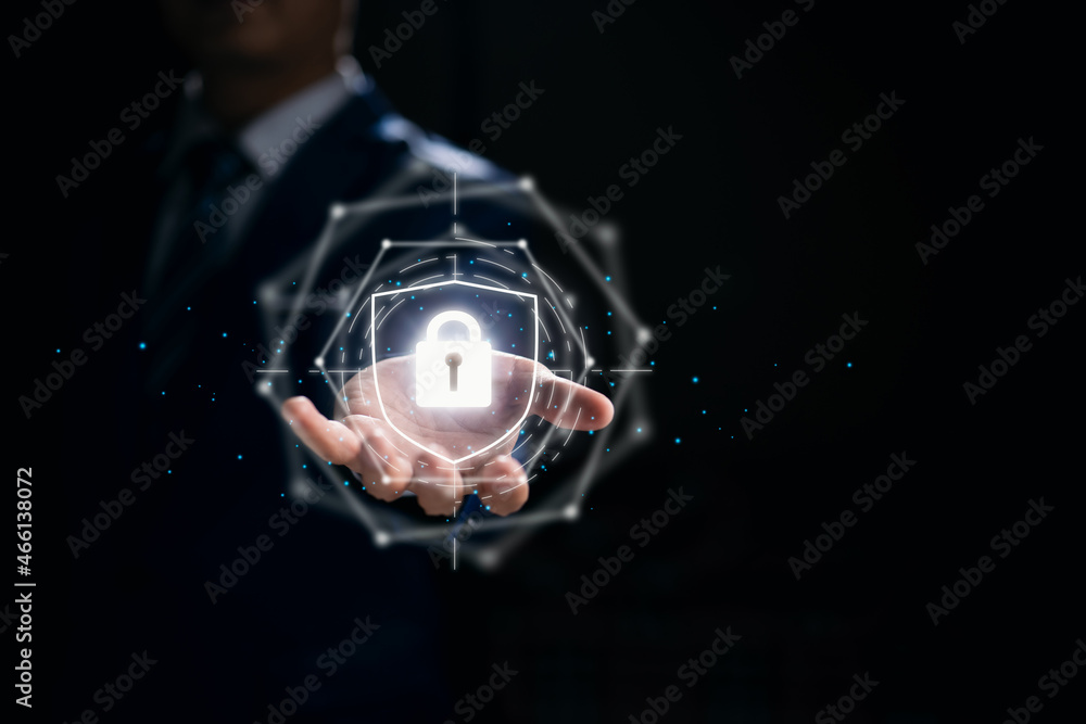 Fototapete Concept of network security computer and data protection, with a businessman holding a shield.