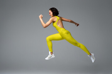 Fototapeta na wymiar Determined sportswoman leaping high in air
