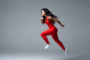 Muscular woman sprinting during workout