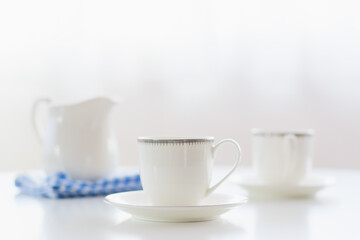 white porcelain tea set on natural background.