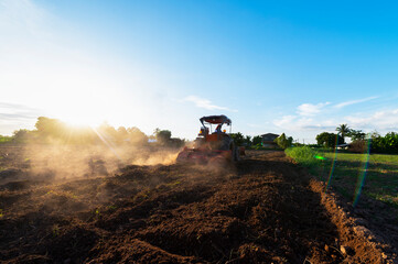 Fototapeta premium Agriculture with tractors prepare the soil with tillage as part of the pre-sowing activity in the early spring of the farm work. farmland