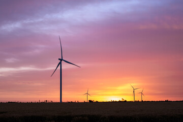 Wind turbines at dawn. Picturesque view of the wind power generator. Production of environmentally friendly energy.