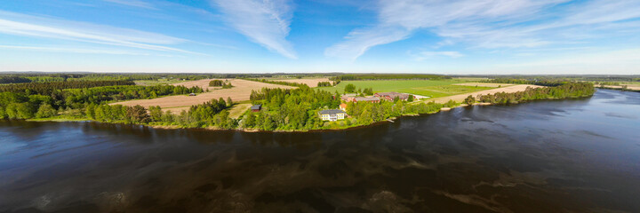 Fototapeta na wymiar Aerial panoramic view of river Kymijoki bank with beautiful wooden Rabbelugn Manor - Takamaan Kartano.