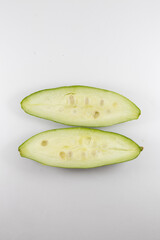 Sliced pointed gourds or potol or parwal green vegetable isolated on white background