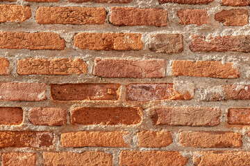 Wall made of red bricks, suitable as background or wallpaper pattern.