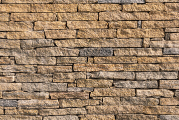 Yellow stone brick wall pattern suitable as wallpaper.