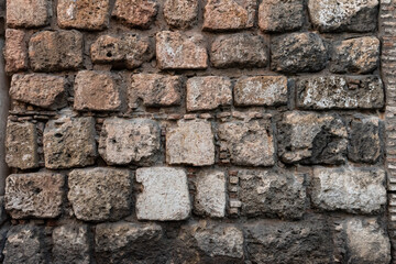 Stone and brick wall of an ancient building. Suitable as background and wallpaper pattern.