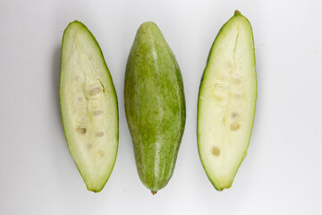 Sliced and whole pointed gourds or potol or parwal green vegetable isolated on white background