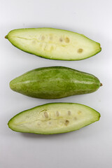 Sliced and whole pointed gourds or potol or parwal green vegetable isolated on white background