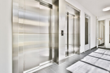 Stylish metal elevator in cozy high-rise building