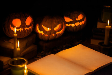 Three smiling jack o lantern with bright light inside. Blank sheet book with place for text. Special for Halloween celebrations.