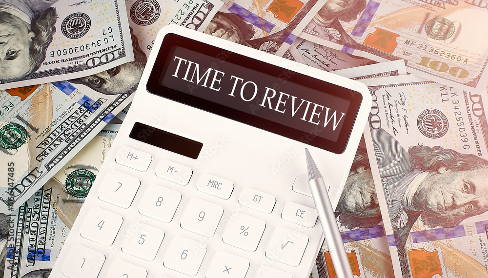 Poster time to review text on display calculator on the dollars background