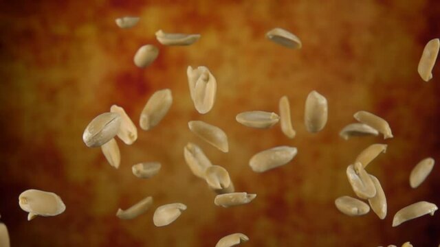 Peeled tasty peanuts are bouncing on a yellow ochre background