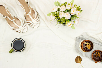 flat lay bed, white shoes and bouquet of flowers, macarons cookies and cup of coffee with copy space. wedding concept 