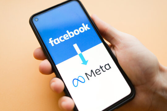 Nizhny Novgorod, Russia October 30 2021: facebook changed its name to meta. screen of smartphone phone with concept of renaming in hand on orange background
