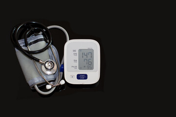 Sphygomanometer digital blood pressure monitor on white with hypertension concept.