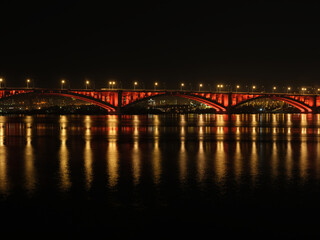 cityscape bridge over the river at night