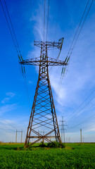 High-voltage power lines. Transmission of electricity by means of poles through agricultural land.