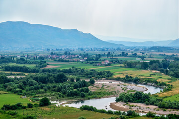 Fototapeta na wymiar Mountain valley with a stream near Rozafa Castle in Albania. Beautiful summer countryside landscape near Shkoder