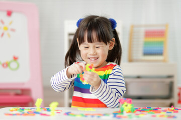 young girl playing creative blocks for homeschooling