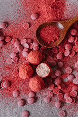 Healthy handmade strawberry candies on gray background. Cheese truffles. Freeze-dried strawberries