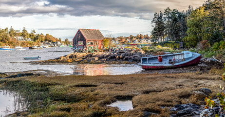 Fishing boats, old and new, a lobster shack, and scattered trap floats fill the harbor scene at Mackerel Cove on Bailey Island at the tip of the rocky Harpswell Peninsula of Down East Maine.