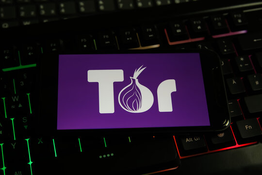 Viersen, Germany - June 9. 2021:  Closeup of mobile phone screen with logo lettering of tor orbot browser on computer keyboard