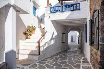 Whitewashed houses cobblestone streets traditional Cyclades architecture Kythnos island Greece.