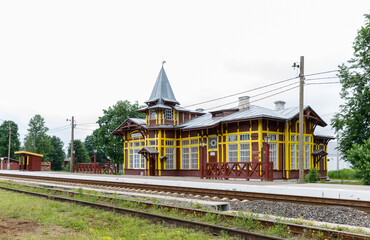 Fototapeta na wymiar Railway station in Kuzhenkino, a historic wooden station building built in 1907. Tver region Russia.