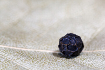 A pea of ​​black pepper. Photo. Macro.