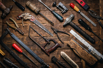 Various old retro style construction work tools on the wooden workbench flat lay background.