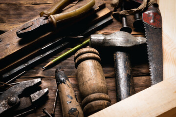 Construction work tools on the carpenter workbench background close up.