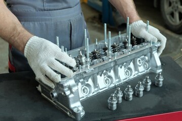 Cylinder head of an internal combustion engine. Repair and maintenance of a car in a car service center.