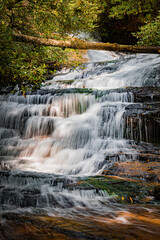 Beautiful Camp Creek falls flows over rocks in Pisgah Forest