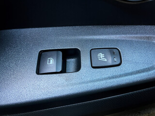 The interior of the car. Window opening and closing buttons, seat heating on and off