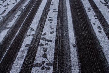 traces of car tires on a winter road