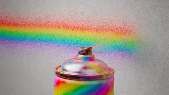 Close up on multicolour spray paint sprays on the wall. Rainbow colour line.
