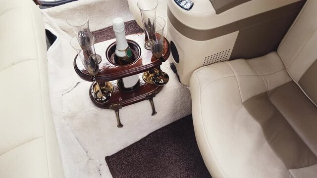 Interior of a wedding limousine with champagne wine at backseat, neo-classic car Cmc Tiffany