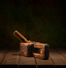 Old wooden dishes with a pestle on a wooden table and art background