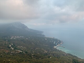 Fototapeta na wymiar view from behind the clouds (height) on the Black Sea coast (Yalta)
