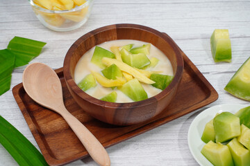 Thai dessert, melon and yellow jackfruit Topped with sugar syrup, fresh coconut milk and pandan leaves add aroma