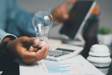 businessman holding light bulb and brain graphic inside It represents the imagination of business networking technology innovation.	