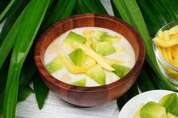 Thai dessert, melon and yellow jackfruit Topped with sugar syrup, fresh coconut milk and pandan leaves add aroma