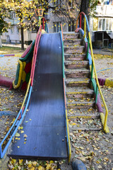 Large children's slide for skating made of iron and concrete with a descent and a ladder