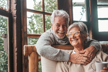 Portrait of couple of two happy and healthy seniors old people smiling and looking at the camera....