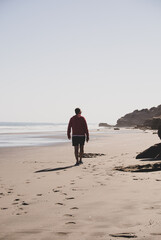 Lonely man walking on the beach. travel concept. patagonia argentina