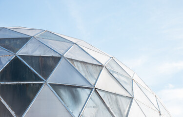 Construction of a glass dome on a background of blue sky. Quality image for your project