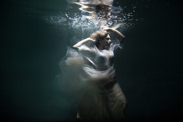 bride under water in a beautiful white dress