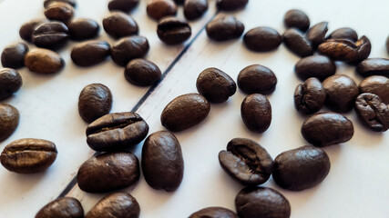 Organic Brazilian coffee beans background, scattered dark coffee beans